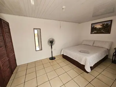 a bedroom with a bed and a fan in it at La casa de Eu in Atenas