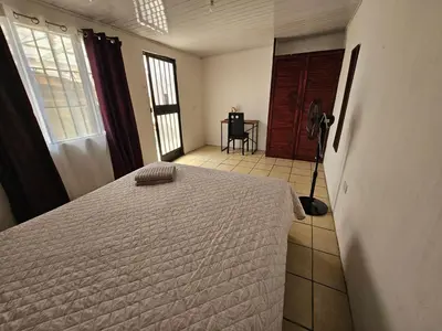 a bedroom with a bed and a room with a table at La casa de Eu in Atenas