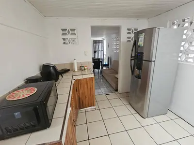 a kitchen with a refrigerator and a stove in it at La casa de Eu in Atenas