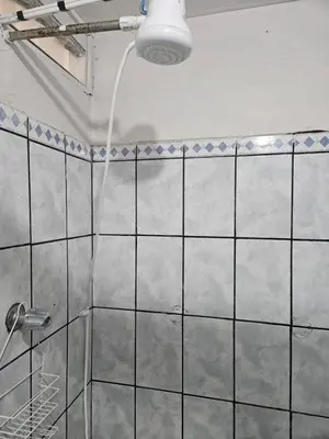 a bathroom with a shower with a shower head at La casa de Eu in Atenas