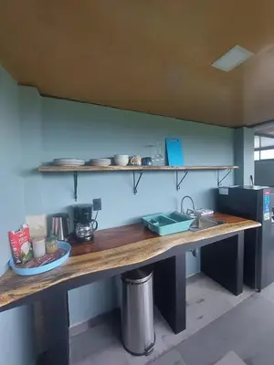 a kitchen with a counter with a sink and shelves at Arenal volcano apartment with panoramic view in El Castillo de La Fortuna