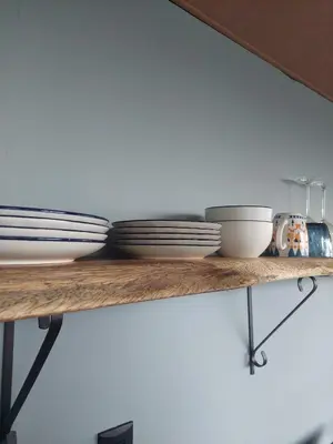 a shelf with plates and bowls on it at Arenal volcano apartment with panoramic view in El Castillo de La Fortuna