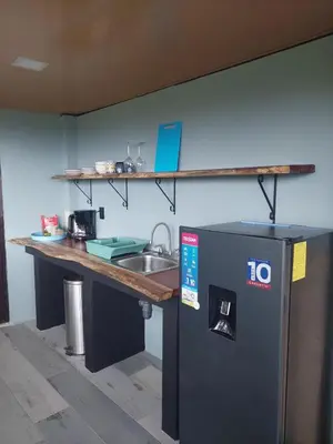 a kitchen with a counter and a sink and a counter top at Arenal volcano apartment with panoramic view in El Castillo de La Fortuna
