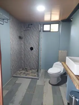 a bathroom with a shower with a toilet and a sink at Arenal volcano apartment with panoramic view in El Castillo de La Fortuna