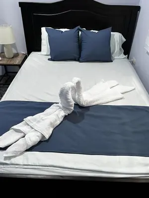 a towel animal is laying on a bed at Paraiso Valle Azul in Puntarenas
