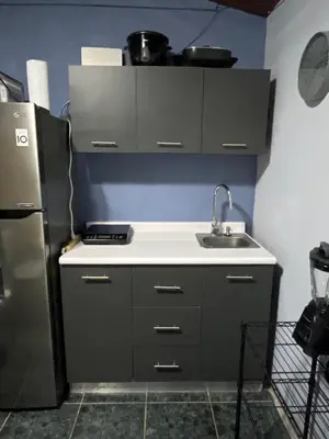 a kitchen with a sink and a refrigerator at Paraiso Valle Azul in Puntarenas