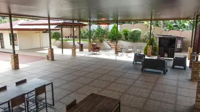 a lobby with chairs and tables and a fireplace at Quinta Issazu in Juntas