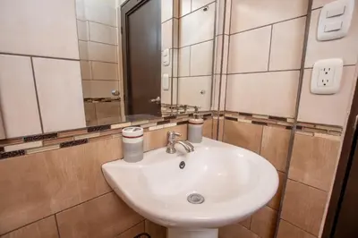 a bathroom with a white sink and a mirror at Quinta Issazu in Juntas