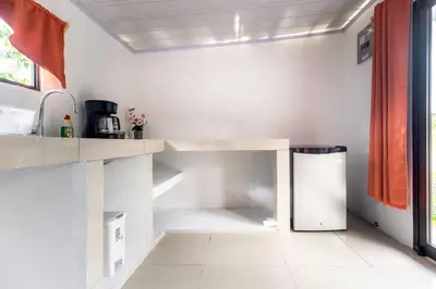 a kitchen with a counter and a refrigerator at Pozas y Cascadas La Presa Habitación 3 in Río Cuarto