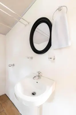 a bathroom with a white sink and a mirror at Pozas y Cascadas La Presa Habitación 3 in Río Cuarto