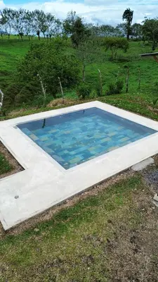 a swimming pool in the middle of a field at Pozas y Cascadas La Presa Habitación 3 in Río Cuarto