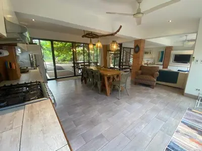 a kitchen and living room with a table and chairs at CASA NiCO in Río Sequito