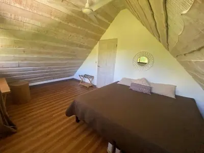 a bedroom with a large bed in a attic at CASA NiCO in Río Sequito