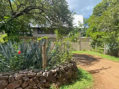 a stone retaining wall in front of a house at CASA NiCO in Río Sequito
