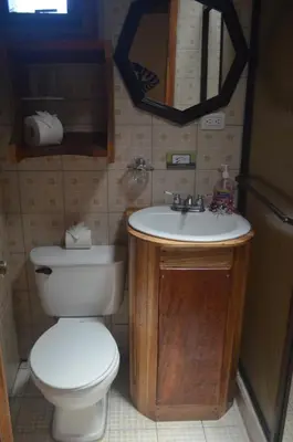 a bathroom with a toilet and a sink at Historias Lodge in Monteverde Costa Rica