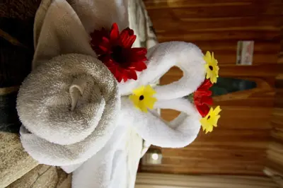 a group of towels with flowers on a wall at Historias Lodge in Monteverde Costa Rica