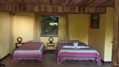 a bedroom with two beds and a window at Historias Lodge in Monteverde Costa Rica