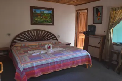 a bedroom with a bed with a stuffed animal on it at Historias Lodge in Monteverde Costa Rica