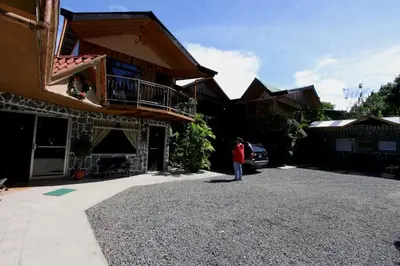 a person standing in the driveway of a house at Historias Lodge in Monteverde Costa Rica