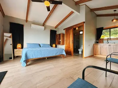a large bedroom with a bed and a bathroom at EcoVilla with Pool & HotSprings in Fortuna