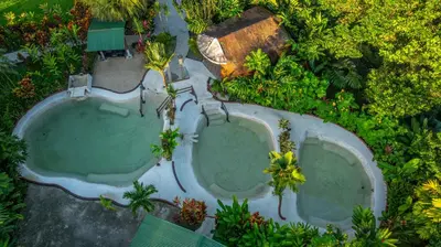 an overhead view of two swimming pools in a resort at EcoVilla with Pool & HotSprings in Fortuna