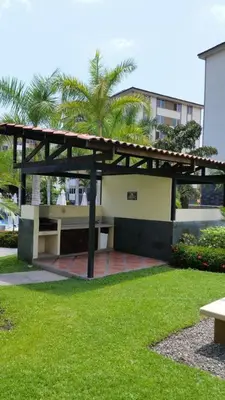 a pavilion with a picnic table in a park at Jaco Beach Condos in Jacó