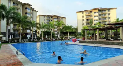 a group of people in the swimming pool at a resort at Jaco Beach Condos in Jacó
