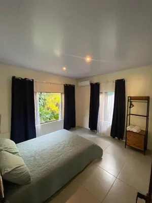 a bedroom with a large bed and a window at Casa El Rio in Estero