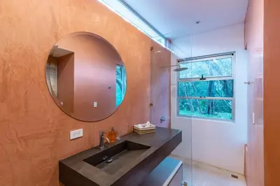 a bathroom with a sink and a mirror at Green House 1 in Nosara