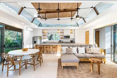 a living room with a couch and a table at Green House 1 in Nosara