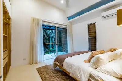 a bedroom with a bed and a large window at Green House 2 in Nicoya