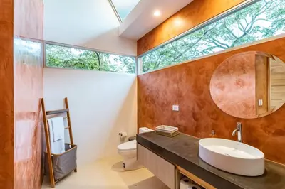 a bathroom with a sink and a mirror at Green House 2 in Nicoya