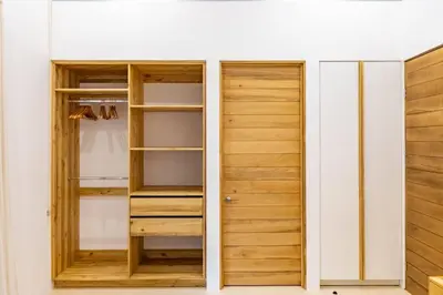 a closet with wooden doors and shelves at Green House 2 in Nicoya