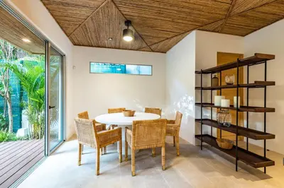 a dining room with a table and chairs at Green House 2 in Nicoya