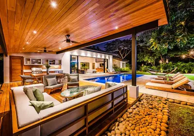 an outdoor living room with a swimming pool at Xanadu Luxury Villa 5BR - 10P Tamarindo - Hacienda Pinilla in Tamarindo