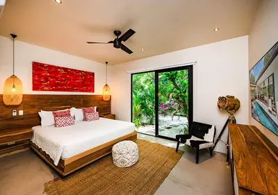 a bedroom with a bed and a large window at Xanadu Luxury Villa 5BR - 10P Tamarindo - Hacienda Pinilla in Tamarindo