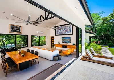 a living room with a couch and a table at Xanadu Luxury Villa 5BR - 10P Tamarindo - Hacienda Pinilla in Tamarindo