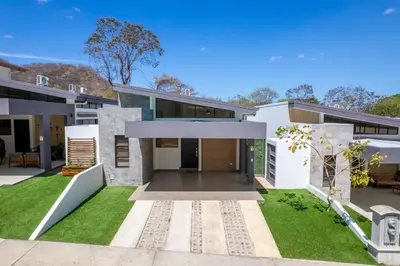a large white house with a yard with grass at Sophisticated Home with a Chic Design and a Private Terrace with a Plunge Pool in Artola