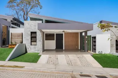 a modern house with a large front yard at Sophisticated Home with a Chic Design and a Private Terrace with a Plunge Pool in Artola