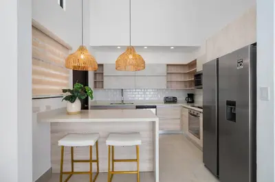 a kitchen with a white counter and a refrigerator at Sophisticated Home with a Chic Design and a Private Terrace with a Plunge Pool in Artola