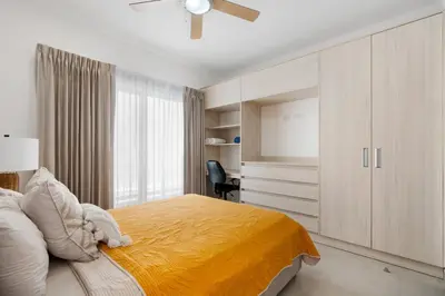 a bedroom with a bed with a yellow blanket at Sophisticated Home with a Chic Design and a Private Terrace with a Plunge Pool in Artola