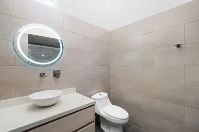 a bathroom with a toilet and a sink and a mirror at Sophisticated Home with a Chic Design and a Private Terrace with a Plunge Pool in Artola