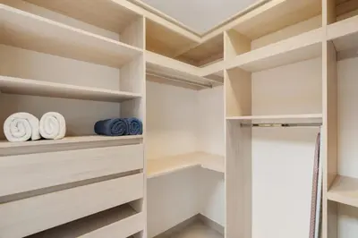 a walk in closet with wooden shelves at Sophisticated Home with a Chic Design and a Private Terrace with a Plunge Pool in Artola