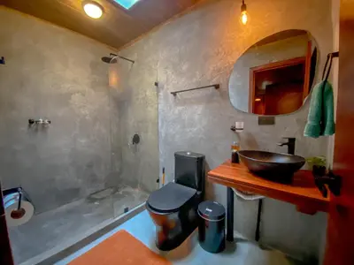 a bathroom with a sink and a toilet and a tub at Casitas la Esquina in Monteverde Costa Rica