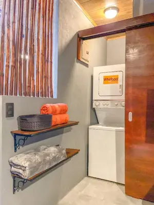 a small kitchen with a refrigerator and some towels at Casitas la Esquina in Monteverde Costa Rica
