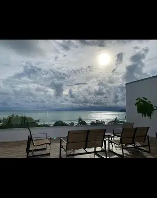 a group of chairs and a table on a balcony at Beachfront Condo Stunning Views in Jacó