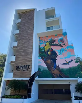 a building with a mural on the side of it at Beachfront Condo Stunning Views in Jacó