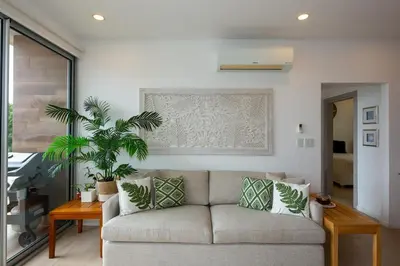 a living room with a couch and a table at Beachfront Condo Stunning Views in Jacó