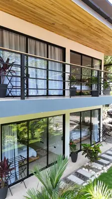 an exterior view of a house with large windows at Aduana House in Santa Teresa Beach