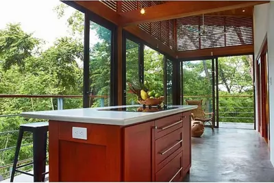 a kitchen with a island in the middle of a porch at Casa Canopy in Nosara